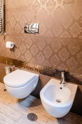 a bathroom with a white toilet and a sink at Locanda Del Sole-Roma Piazza Di Spagna Ripetta in Rome
