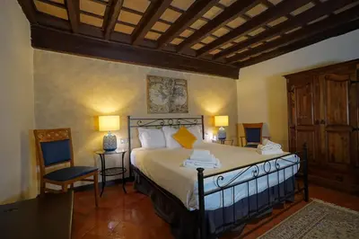 a bedroom with a large bed and two chairs at MGPgroup Rome Center Hot Spot in Rome