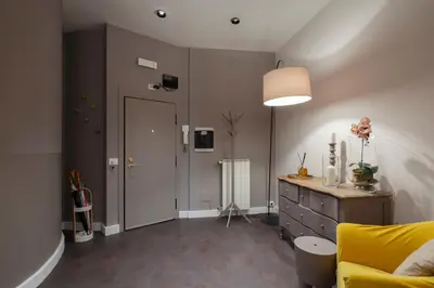 a living room with a yellow couch and a dresser at Trevi Luxury Terrace in Rome