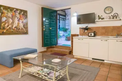 a living room with a blue couch and a table at My Cosy Home in Rome