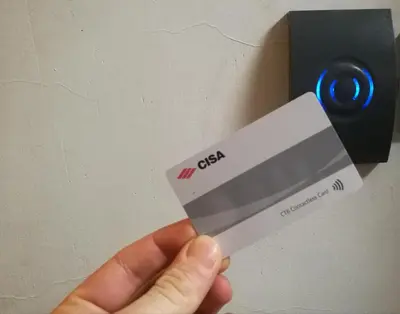 a person holding a credit card in front of a wall at Al Trenino accomodation in Rome