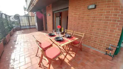 a wooden table and chairs on a patio at Terrace22 - Delizioso attico ben collegato in Rome