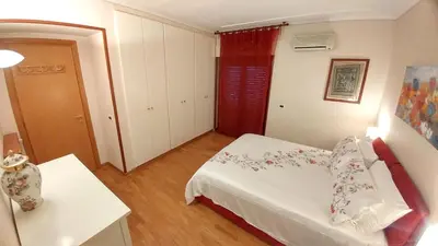 a small bedroom with a white bed and a table at Terrace22 - Delizioso attico ben collegato in Rome