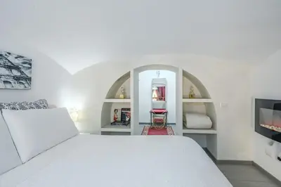 a bedroom with a white bed and a mirror at Diana Romantic Loft in Rome