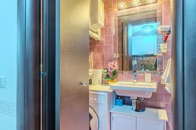 a pink bathroom with a sink and a mirror at Diana Romantic Loft in Rome