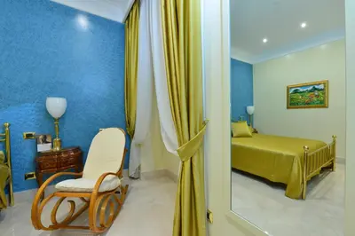 a bedroom with a bed and a chair and a mirror at Fabio dei Velapazza Guesthouse in Rome