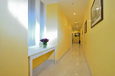 a hallway with a table and a window with flowers on it at Fabio dei Velapazza Guesthouse in Rome
