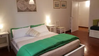 a bedroom with a large bed with green sheets at homedieci in Rome