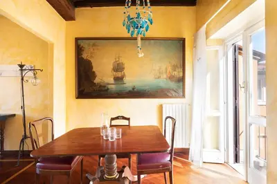 a dining room with a table and a painting on the wall at Trevi Comfortable Apartment with Terrace | Romeloft in Rome