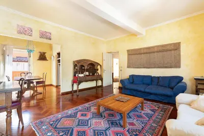 a living room with a blue couch and a table at Trevi Comfortable Apartment with Terrace | Romeloft in Rome