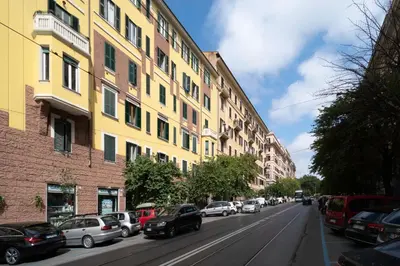 a street with cars parked on the side of a building at At Home Townhouse - Filiberto in Rome