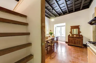 a kitchen and dining room with a table and chairs at Campo dei Fiori Stunning and Quiet in Rome