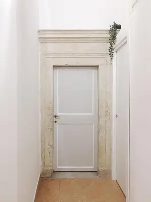 an empty corridor with a white door in a room at Suite Rondanini in Rome