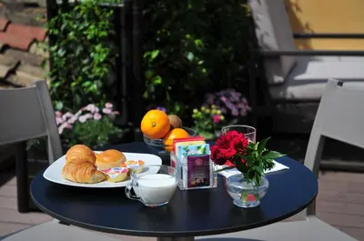 a black table with a plate of food on it at Piccola Navona Roof Garden in Rome