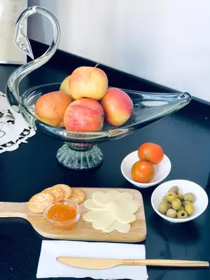 a table topped with a bowl of apples and other foods at Piccola Navona Roof Garden in Rome