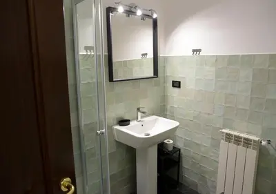 a bathroom with a sink and a mirror at Colosseum Comfortable Apartment in Rome