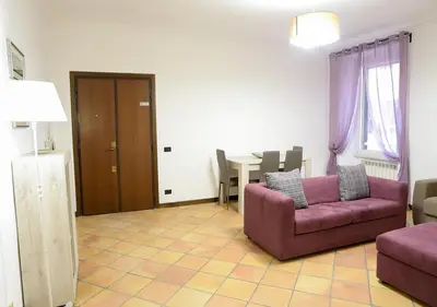 a living room with a purple couch and a table at Colosseum Comfortable Apartment in Rome