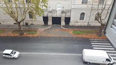 a white van parked on a street next to a building at tagliaferri lucia in Rome
