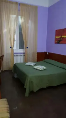 a bedroom with a green bed and a window at tagliaferri lucia in Rome