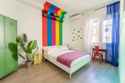 a colorful bedroom with a bed and a colorful wall at House Of Music in Rome