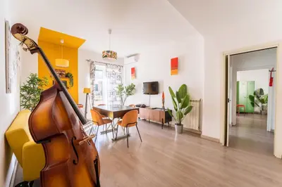 a living room with a guitar and a dining room at House Of Music in Rome