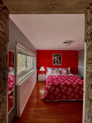 a red bedroom with a bed and a window at Domus Mirabile in Rome
