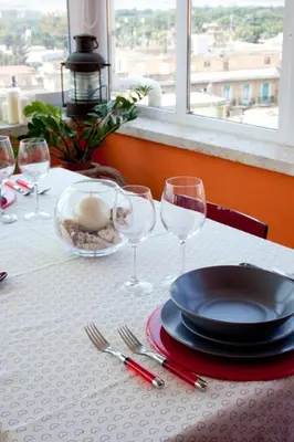 a table with a plate and wine glasses on it at Domus Mirabile in Rome