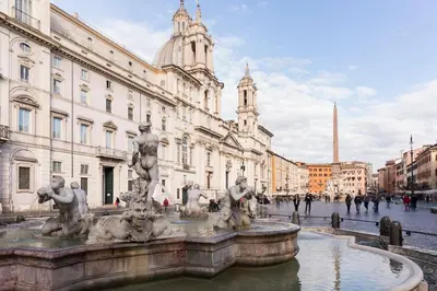 a fountain in the middle of a city with buildings at Central Apartment Navona Square in Rome