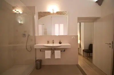 a bathroom with a sink and a shower and a mirror at B&B La finestra sul Colosseo in Rome