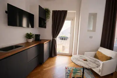 a kitchen with a sink and a table and a window at Gli Artisti Apartments Rome in Rome