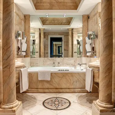 a bathroom with a tub and a large mirror at Hassler Roma in Rome