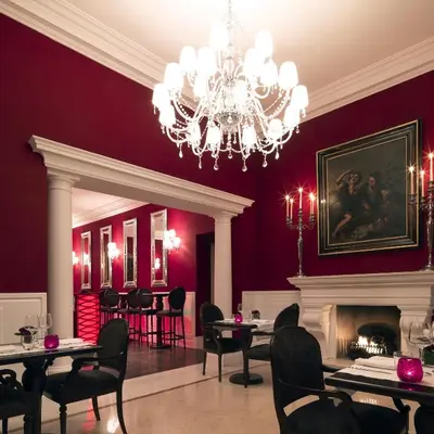 a dining room with purple walls and a chandelier at Il Palazzetto in Rome