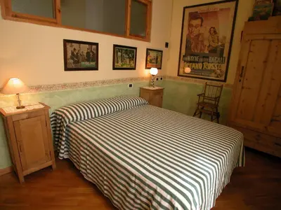 a bedroom with a bed with a striped blanket at Vacanze Romane in Rome
