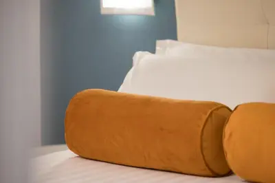 a bed with a brown pillow sitting on top of it at Zaccardi Roof Garden in Rome