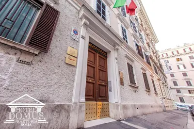a building with a brown door on a street at Hotel Domus Praetoria in Rome