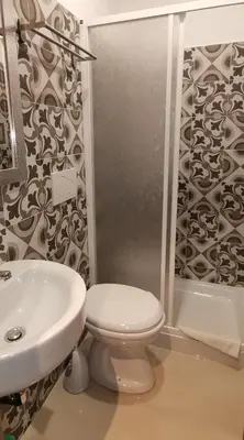 a bathroom with a toilet and a sink and a shower at Sun Moon in Rome