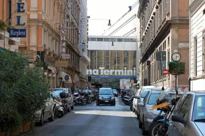 a busy city street with cars parked on the street at Sun Moon in Rome