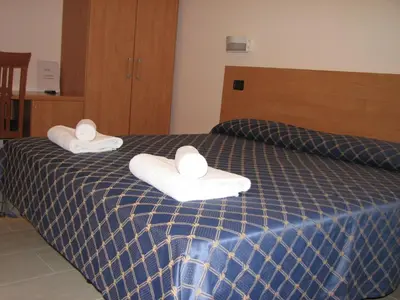 a hotel room with two towels on a bed at Sun Moon in Rome