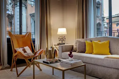 a living room with a couch and a table at Singer Palace Hotel Roma in Rome
