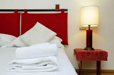 a bedroom with a bed with white towels on it at Saint Peter's Bright Apartment | Romeloft in Rome