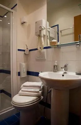 a bathroom with a sink and a toilet and a shower at San Peter Rome B&B in Rome