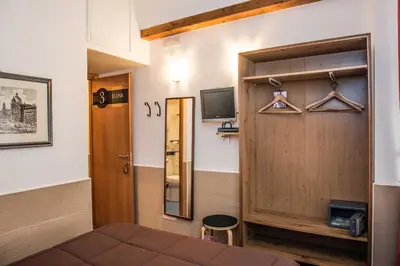 a room with a door and a television and a bed at San Peter Rome B&B in Rome