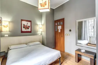 a small bedroom with a bed and a window at Guest House Trastevere in Rome