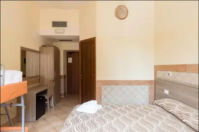 a hotel room with a bed and a desk at Alex Romano in Rome