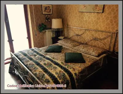 a bedroom with a bed with two green pillows on it at Palini's House in Rome