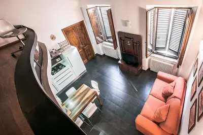 an overhead view of a living room with orange chairs at In Front Of Coliseum in Rome