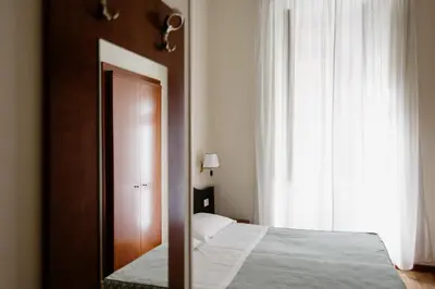 a bedroom with a bed and a large window at La Girandola Bed & Breakfast in Rome