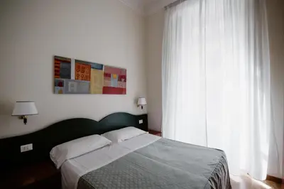 a bedroom with a bed and a large window at La Girandola Bed & Breakfast in Rome