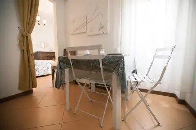 a table and two chairs in a room at La Fabbrica di San Pietro B&B in Rome