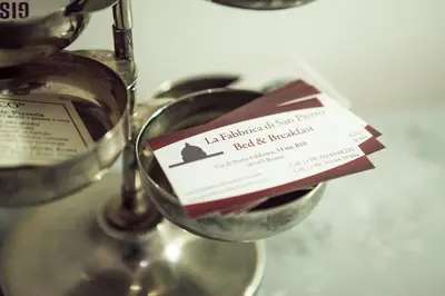 a wine glass with a label on it at La Fabbrica di San Pietro B&B in Rome